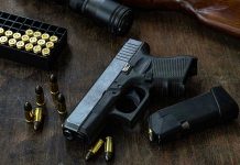 Fatal Shooting Near White House: Trump Makes New Request Handgun with ammunition, magazine, and rifle on wooden table.