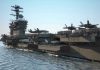 Trump DEPLOYS USS FORD – Where’s It Headed? Aircraft carrier deck with jet planes.