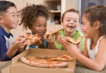 Absolute TERROR: Kids’ Celebration Turns Deadly Four children joyfully sharing slices of pizza around a box
