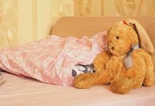 11-Year-Old Forced to Share Bed Sparks Uproar A cozy bedroom scene featuring a stuffed bunny and pink bedding