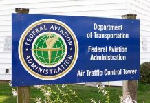Holiday Travel CHAOS: FAA Slashes Airport Traffic Sign for the Federal Aviation Administration at an air traffic control tower
