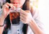 Landmark Lawsuit Takes on Ultra-Processed Foods Person drinking soda from a glass mug