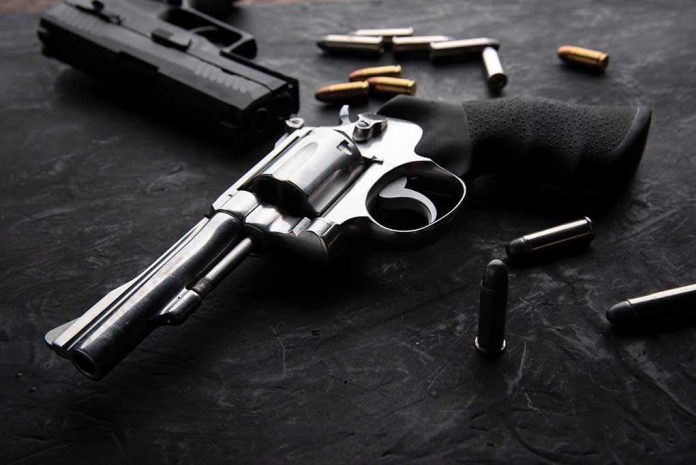 1938010207 Revolvers and bullets on a dark surface.