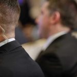 Secret Service Agent in Explosive Fraud Scandal Security personnel with earpiece in a suit.