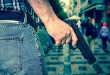 GUNMAN Stalks Rockefeller Center Crowds Person holding a gun in a crowded street.