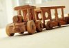 Holiday GIFT Idea: Adults Swap Gadgets for Models A wooden toy train set on a carpeted surface