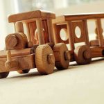 Holiday GIFT Idea: Adults Swap Gadgets for Models A wooden toy train set on a carpeted surface