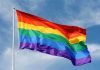Pastor’s Gender Shift SHOCKS Congregation! A rainbow flag waving against a blue sky