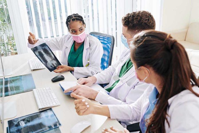 Doctors discussing chest X-ray results at a workstation.