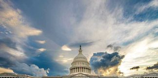 U.S. Capitol building with dramatic cloudy sky.