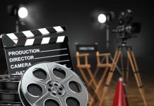 Movie set with film reels and clapperboard.