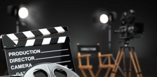 Movie set with film reels and clapperboard.