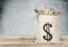 Couple Rips Carpet—$19 MILLION Underneath Bag of money with dollar sign.