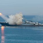 Warship firing missile in the sea.