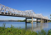 1,400-Ton Bridge Moved—No Cranes! A large metal bridge spanning over a river with a clear blue sky in the background