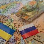 Russia Rejects Deadlines–Ukraine Crumbles! Toy tank on map with Ukraine and Russia flags.