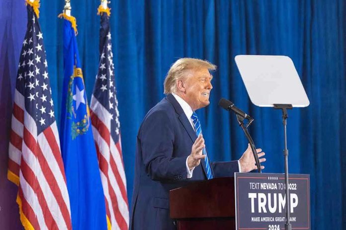 2427935455 Person speaking at podium with flags in background.