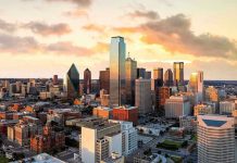 City skyline at sunset with modern skyscrapers.