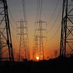 Electricity Rates EXPLODE By Shocking 83% Transmission towers at sunset.