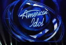 American Idol logo illuminated in blue lights on stage