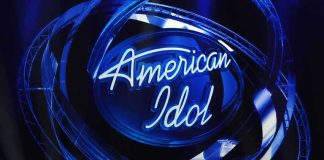 American Idol logo illuminated in blue lights on stage