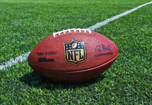 NFL Star ARRESTED – Disturbing Recording LEAKED An NFL football resting on a green grass field