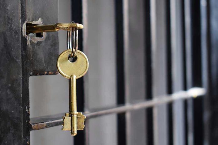Key in lock of prison cell door.