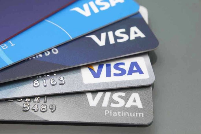 Stacked Visa credit cards in various colors.
