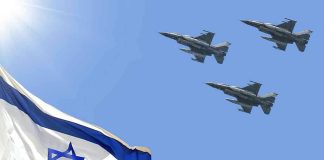 Israeli flag with three fighter jets in flight.