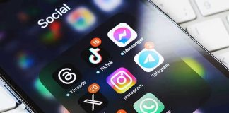 Passwords Now Punishable by Prison Smartphone showing social media app icons in a folder.