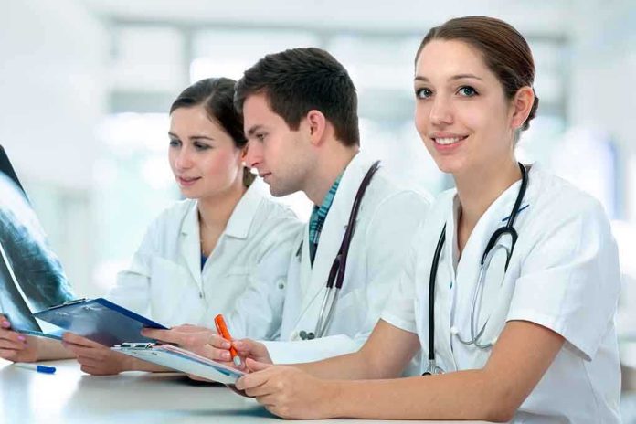 shutterstock_121287175.jpg Three medical professionals reviewing patient x-rays in a healthcare setting