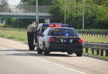 Police officer conducting a traffic stop on a highway
