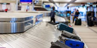 Luggage on a conveyor belt at an airport baggage claim area
