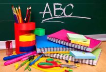 A collection of colorful school supplies including notebooks, pens, and scissors on a desk