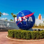 Nine Scientists DEAD — NASA Says Nothing NASA logo sculpture with spaceship and palm trees.