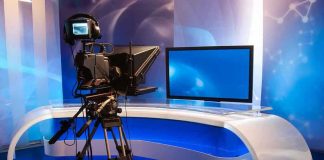Jesus “Narcissist” Comment IGNITES Firestorm TV studio with camera and empty anchor desk.