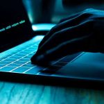 Legendary Developers Abandon Traditional Coding Hand typing on laptop with code on screen.