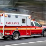Bull Run TRAGEDY — Escape Attempt Goes Horribly Wrong Red and white ambulance driving on street.
