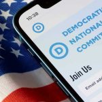 Democrat CAUGHT Posing as Republican Under Oath Phone displaying Democratic National Committee website over flag.
