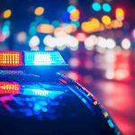 BEATEN Impersonator Sparked National Outrage Police car with flashing lights at night.