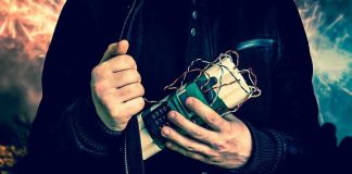 Person holding a homemade explosive device.