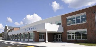 Pro-Life Poem BANNED: Outrage at School Censorship Modern school building with large windows and a clear sky