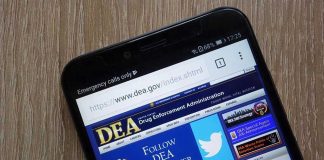DEA Watched — Millions Of Pills Rolled DEA website open on smartphone screen.