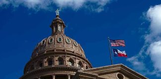 Texas Judges Get A Faith Pass Building dome with US and Texas flags, blue sky.