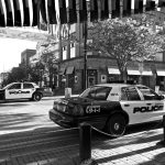 Police cars parked on a city street corner