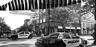 Drive-Thru Dispute Turns Deadly Police cars parked on a city street corner