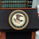 CHAMBERS SCANDAL Rocks Federal Bench Podium with the Department of Justice seal and American flag in the background