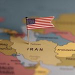A map highlighting Iran with a small American flag pin