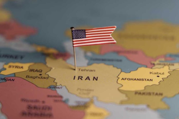 shutterstock_2643320287 A map highlighting Iran with a small American flag pin
