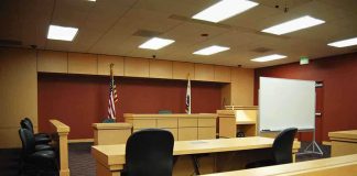 Corpse Rape on NY Subway Train Interior view of an empty courtroom with wooden furniture and American flags